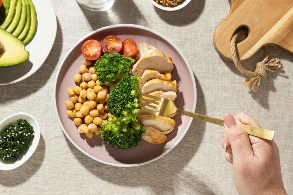 Colorful plate filled with fresh vegetables, grains, and legumes, representing a balanced plant-based meal.